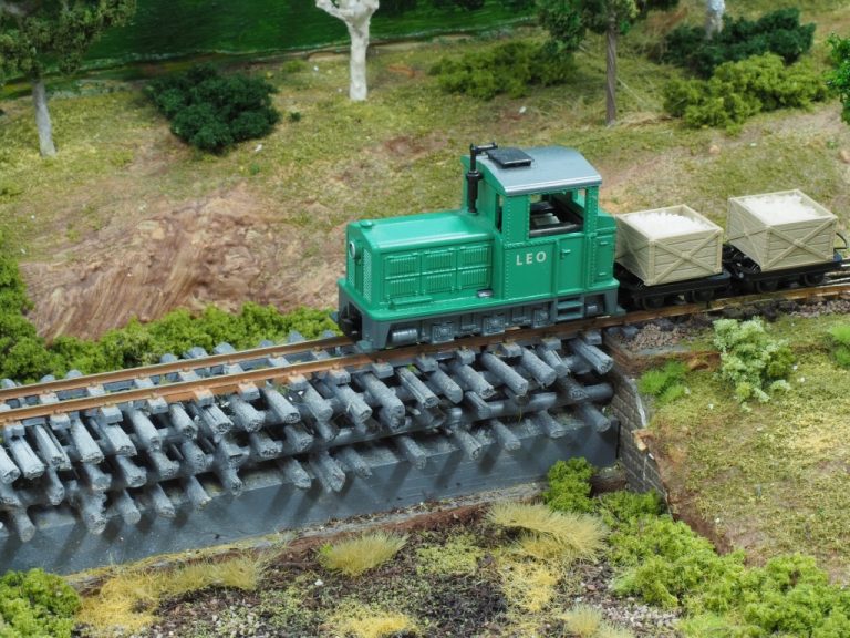 Hauled by Loco across unique log bridge over swampy lagoon